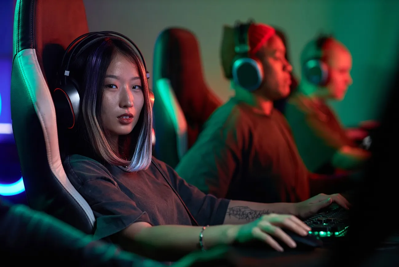 Esports girl on a gaming chair, playing a game in a environment with red and green lights