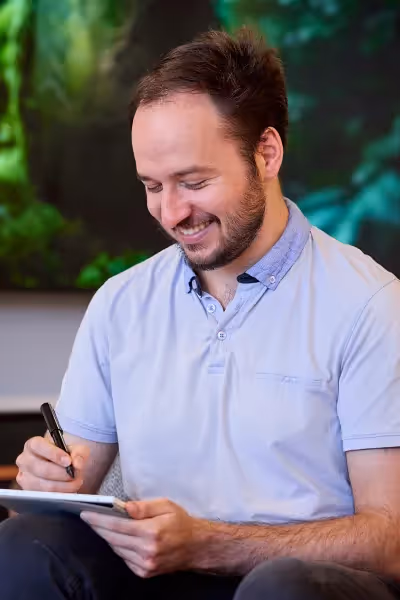 Kamen taking notes and smilling